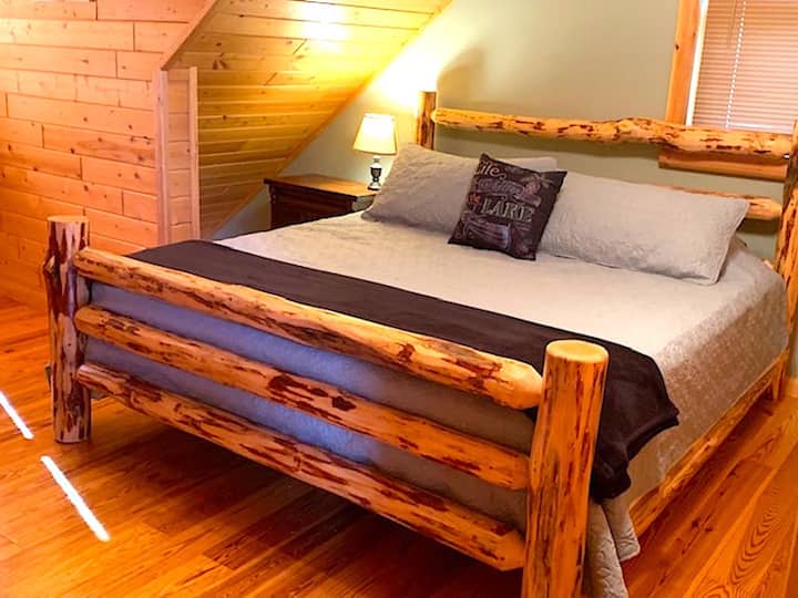 The second guest bedroom with a king log bed 