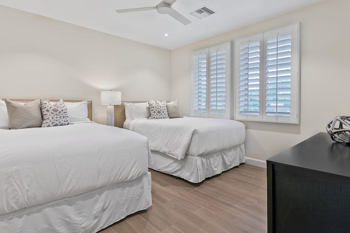 Casita bedroom with it's own en suite bathroom and two queen beds.