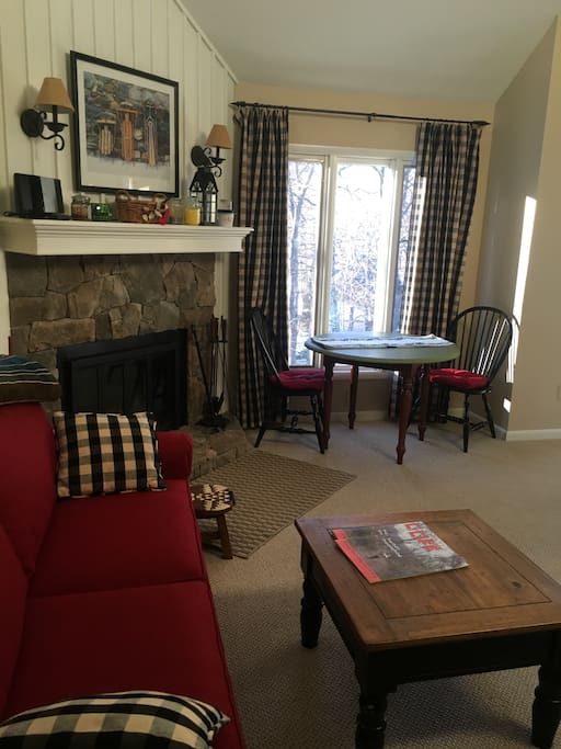 A comfortable living area with a fireplace to keep you warm after the day is done. There are extra chairs for the table in the bump out room. Firewood is stocked by the Association, so you will not run out.