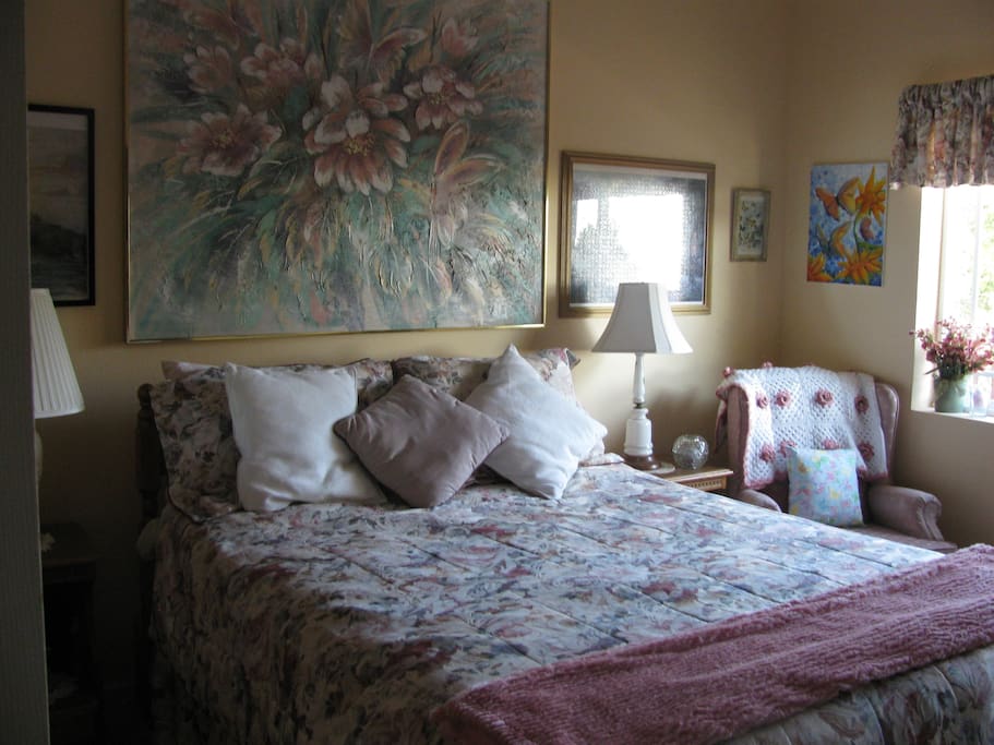 Private Bedroom with queen bed, sofa, TV, refrigerator, outside access to large deck, and full bath