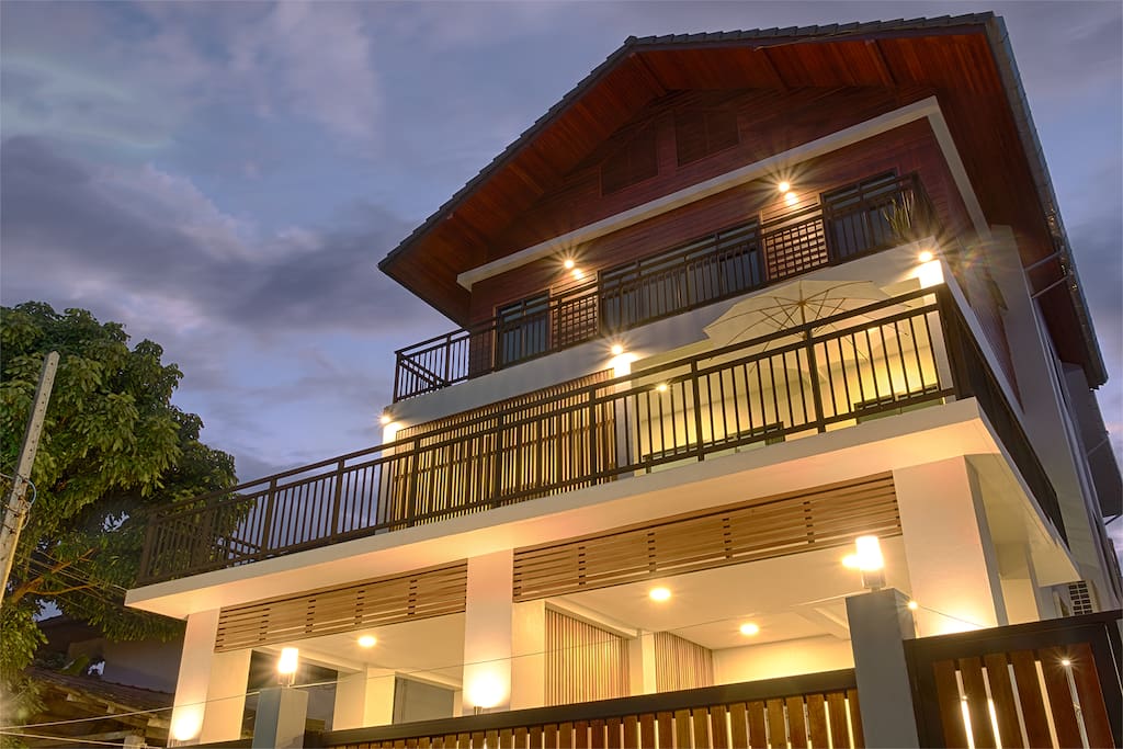 Three story house with two balconies.