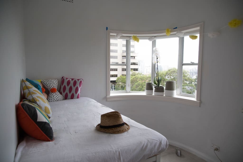 Bedroom 2: Sunroom with daybed, set high with a city view. Daybed is the size of a single bed.