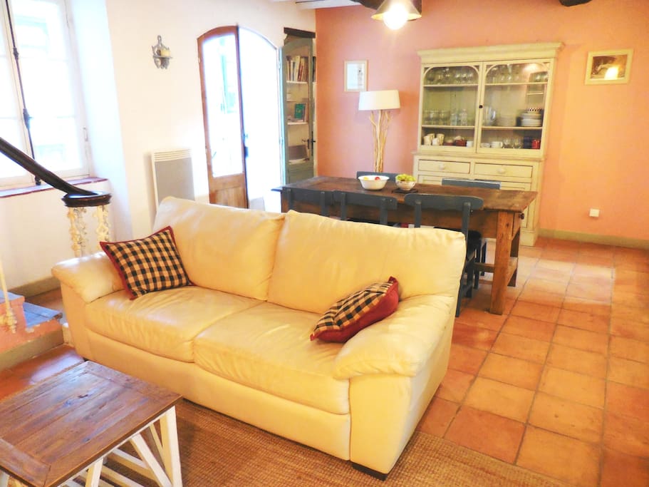 The living/dining room and doorway to the sunroom and courtyard