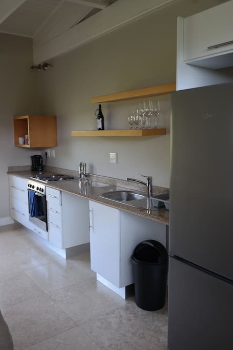 Kitchenette with full oven, fridge and crockery / cutlery