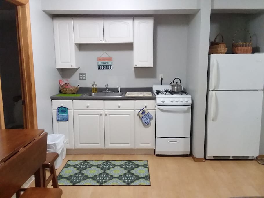 Kitchen with new stove, oven and full size refrigerator.