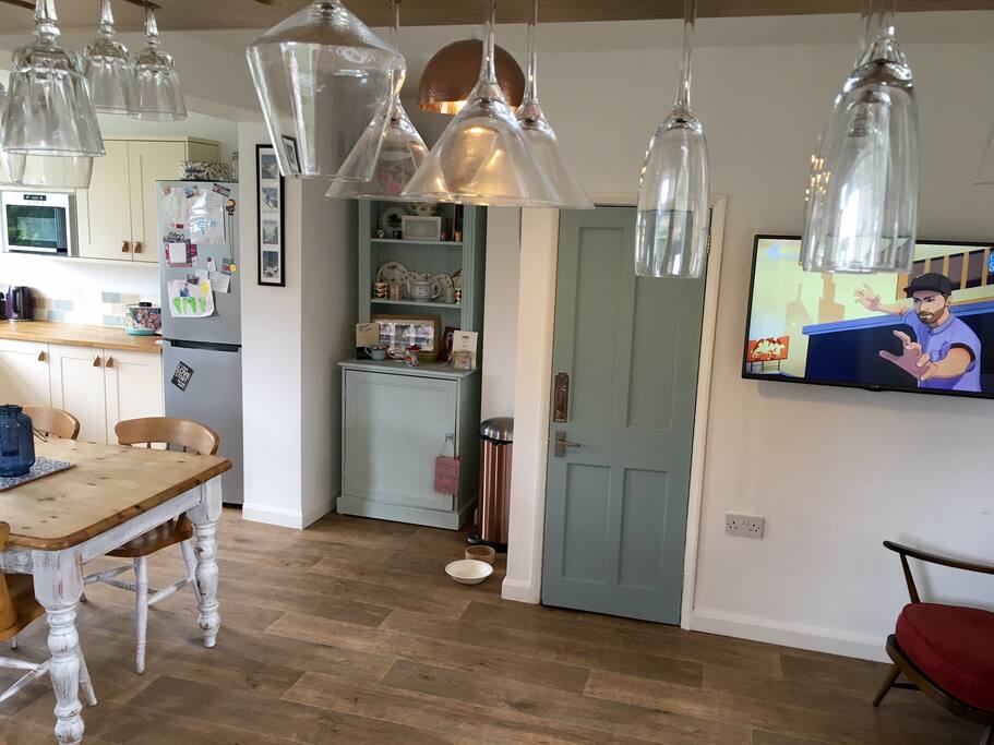 Kitchen and dining area with wall mounted TV