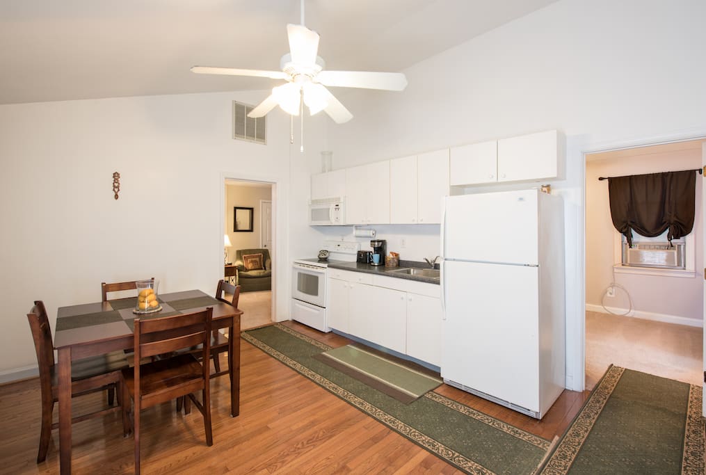 Full kitchen with microwave, k-cup coffee maker, and table for four.