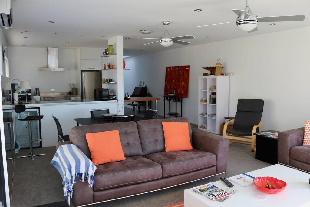 Open plan living space complete with flatscreen TV and heatpump