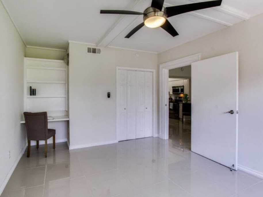 Bedroom without bed so you can see the built in desk and closet