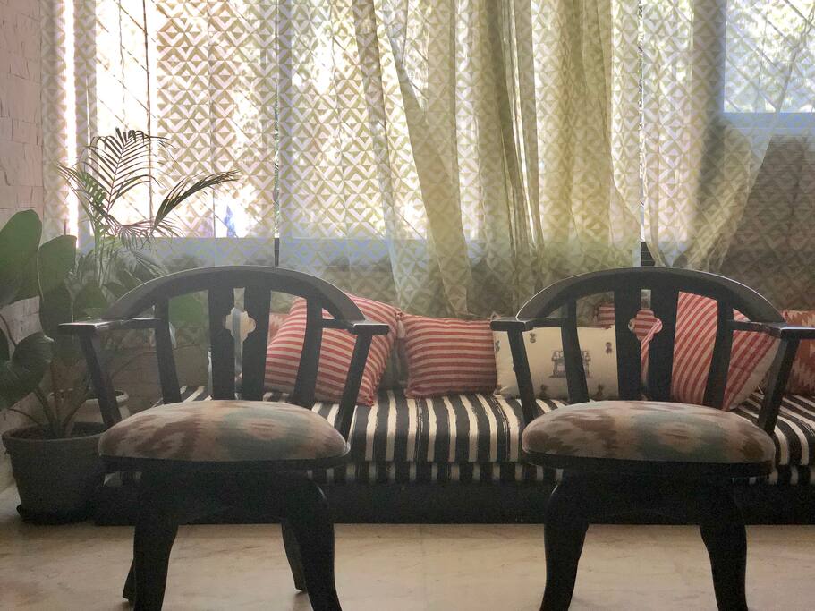 Living room - spacious common area - has 2 couches, one day bed, dining table, tv, coffee table and an air conditioner.