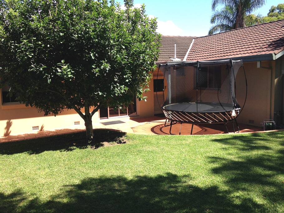 Kid friendly backyard with trampoline, fort and herb garden. Hi from your g