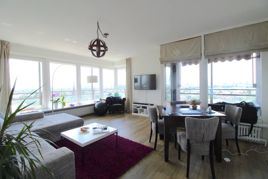 The spacious and bright living room offers a comfortable couch, a modern TV and a dining table for up to 4 persons.