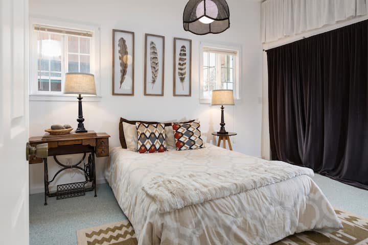 Second bedroom with queen size bed. The washer and dryer are behind the curtain. 