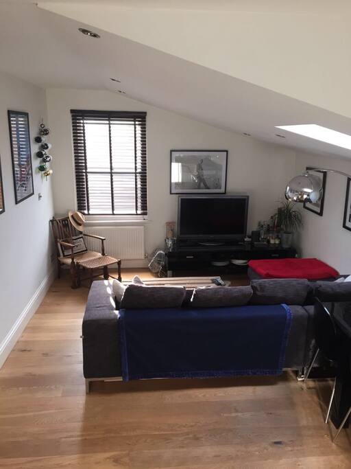 Lounge area with large flat screen TV (view from kitchen)