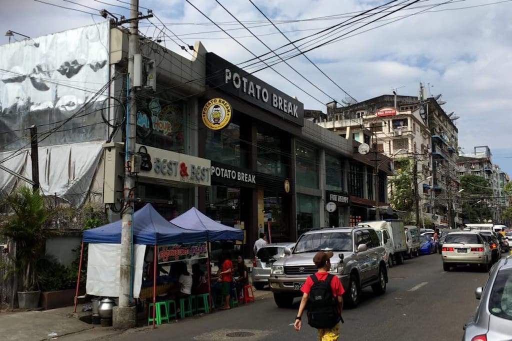 The apartment is on a main street with many food outlets and local stores