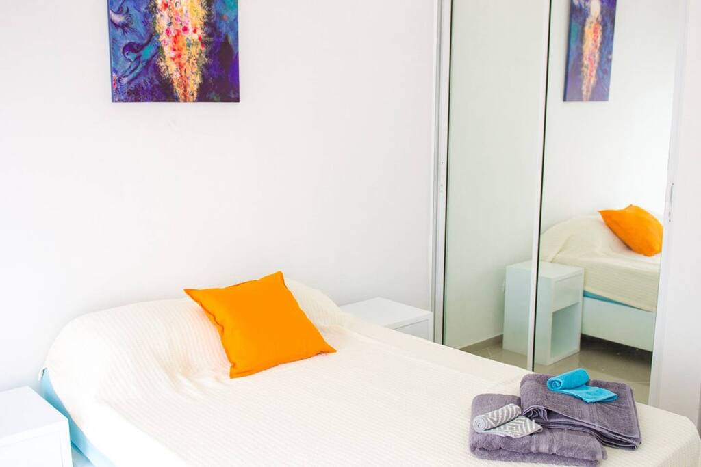 Beach nearby apartment, you'll love this private bedroom, king size bed, night tables, armchair, en-suite bathroom.