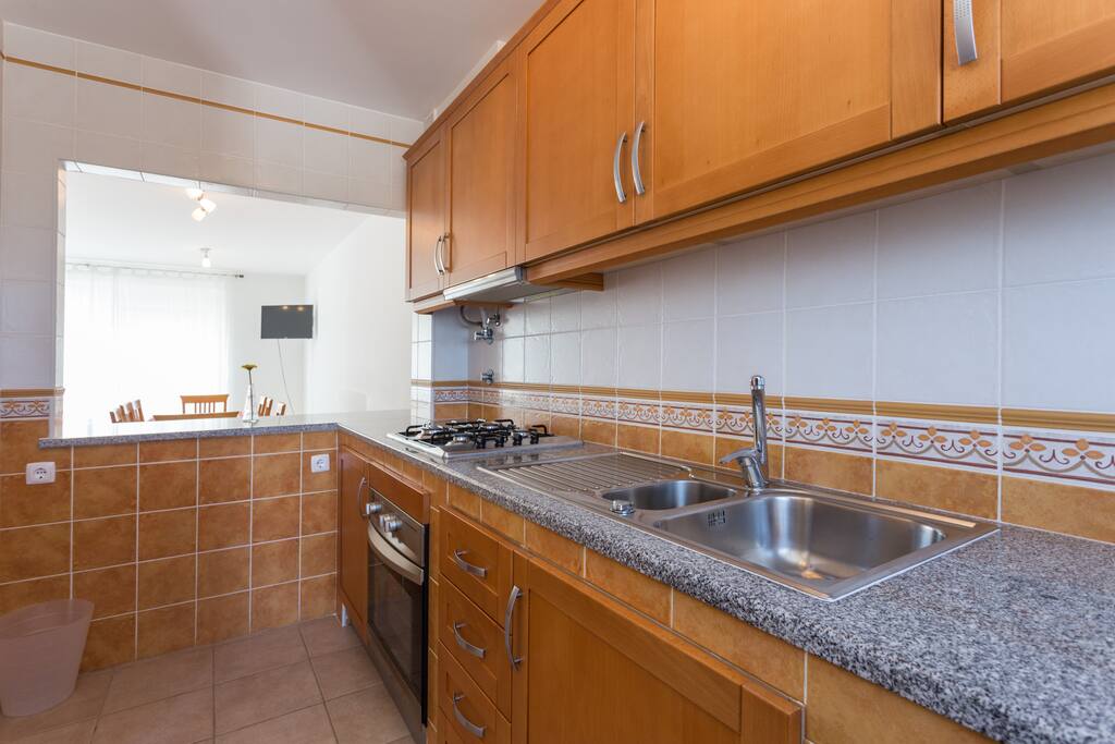American kitchen with opening to dining room to pass dishes.