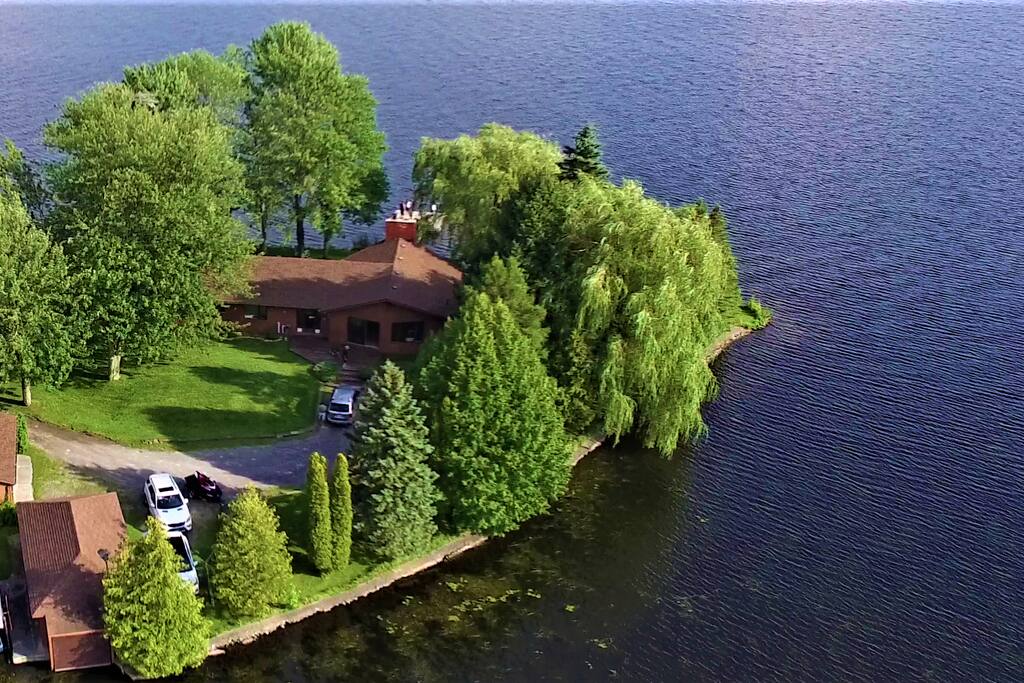 Aerial view overlooking the cottage, boathouse, and garage