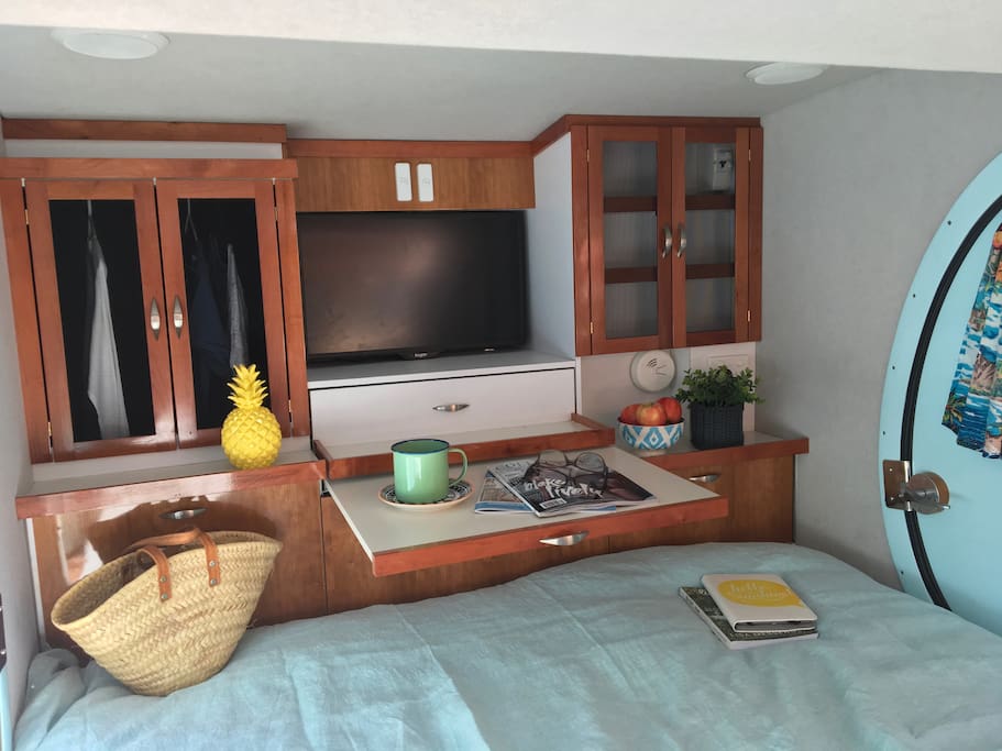TV which rotates to also appears through the kitchen! Slide out table. Hanging space and drawers/shelves