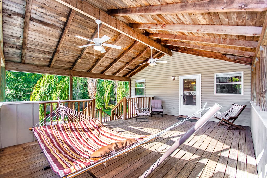 Spacious deck has ceiling fans, plenty of light, a sitting area, and a hammock perfect for relaxing.