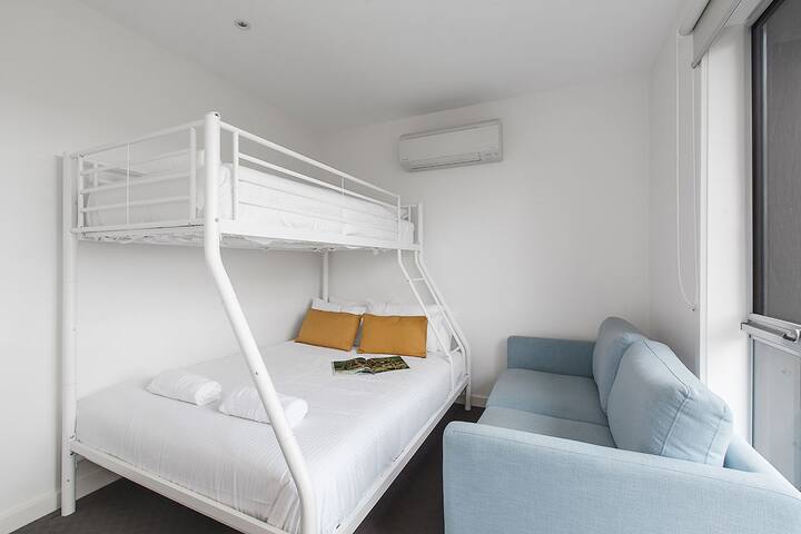 Located on the main floor, the third bedroom is fitted with a double bunk bed, sleeping three guests in total.