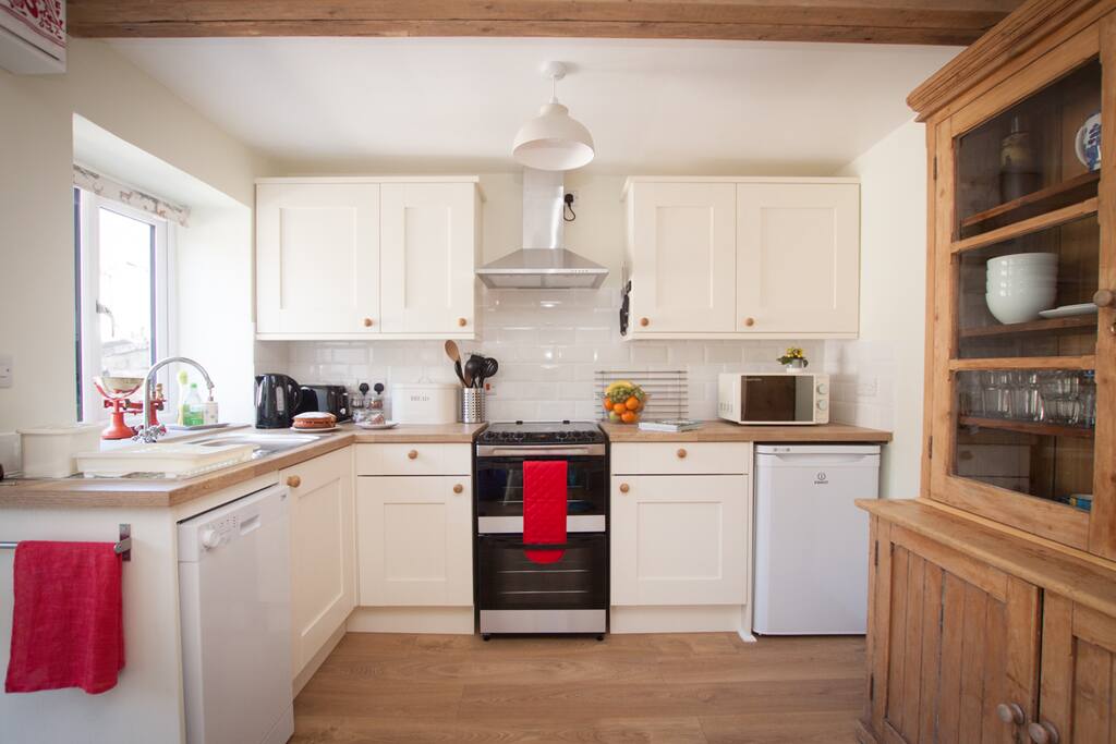 The light, bright well equipped kitchen.