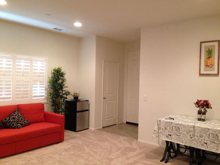 living room with a sofa convertible to a double bed;
small refrigerator included at the corner.
