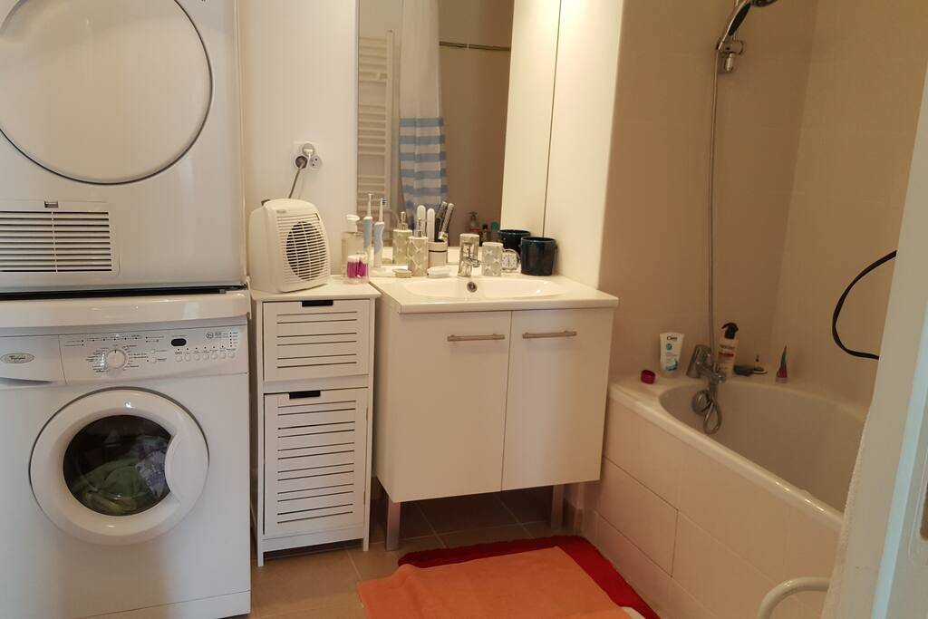Salle de bain avec lave-linge et sèche-linge à disposition