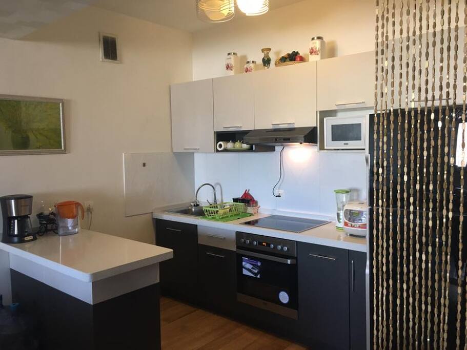 Proper sweet kitchen that has coffee maker and water filter