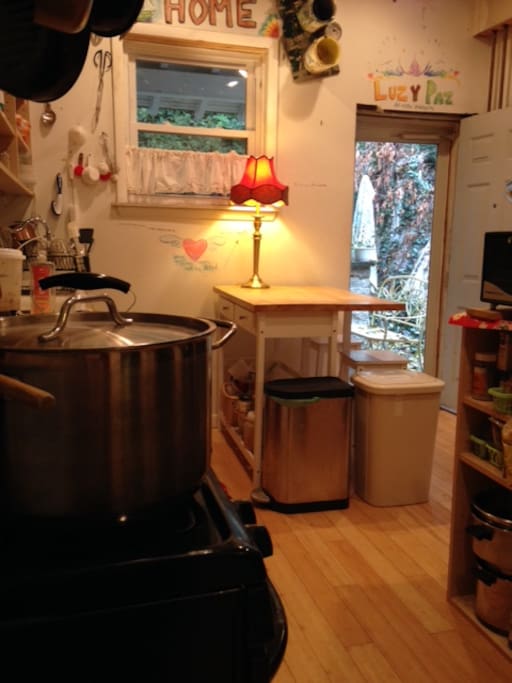 Simple kitchen with access to small back yard with seating