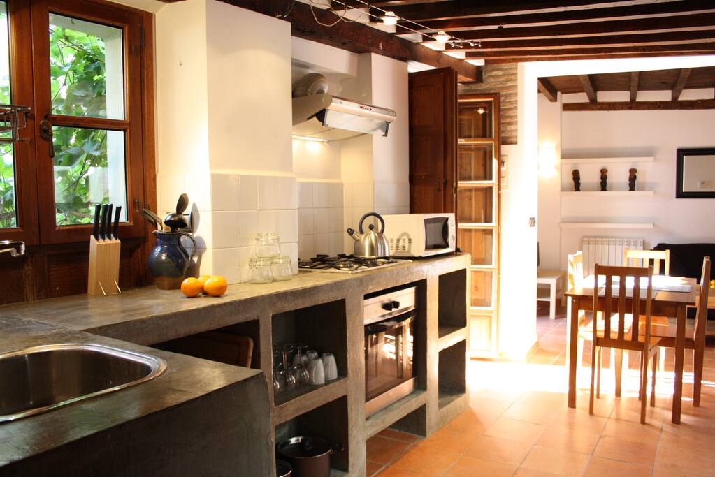 Polished cement kitchen with kettle, toaster, oven etc
