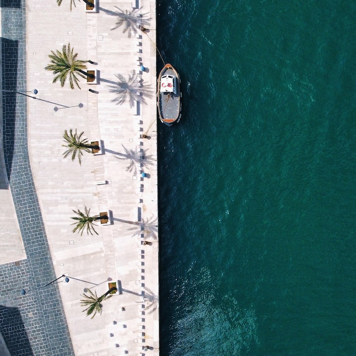 image of a boat docked near a boardwalk