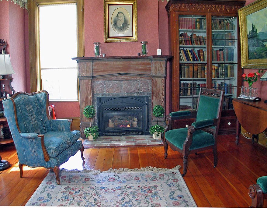 The back parlor with fireplace. Place to chat and visit, read o play board games, even sip a glass of wine!