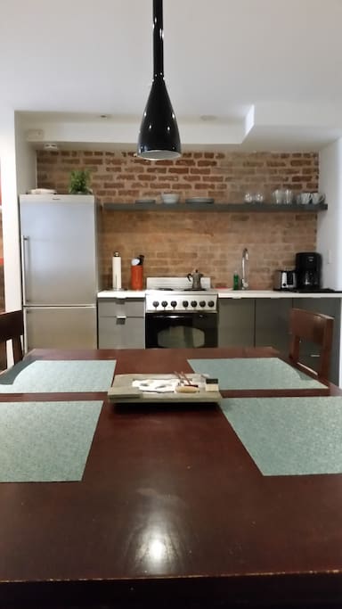 Kitchen includes refrigerator, oven, stove, toaster, coffee maker, and essential pots, utensils and dishes.