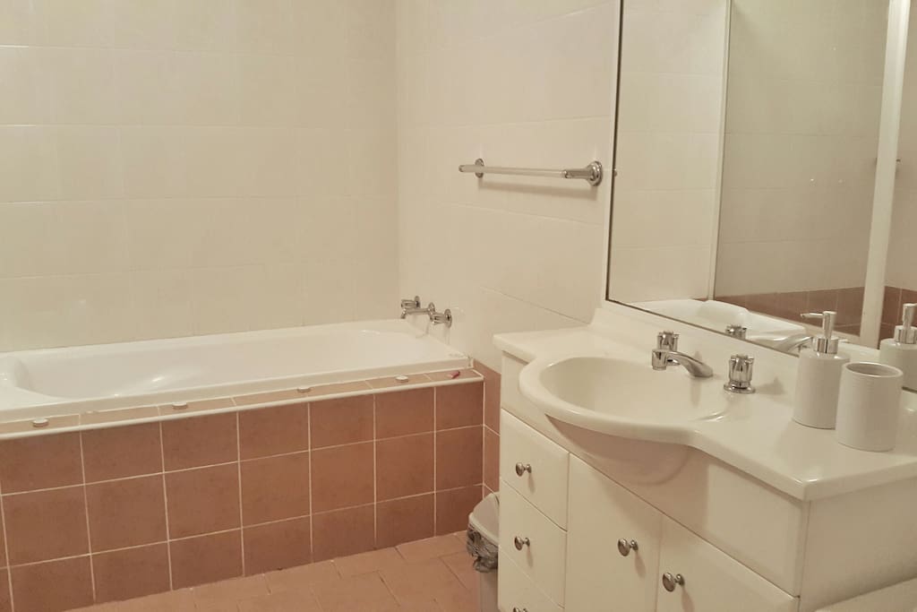 Private washroom with bathtub and separate shower