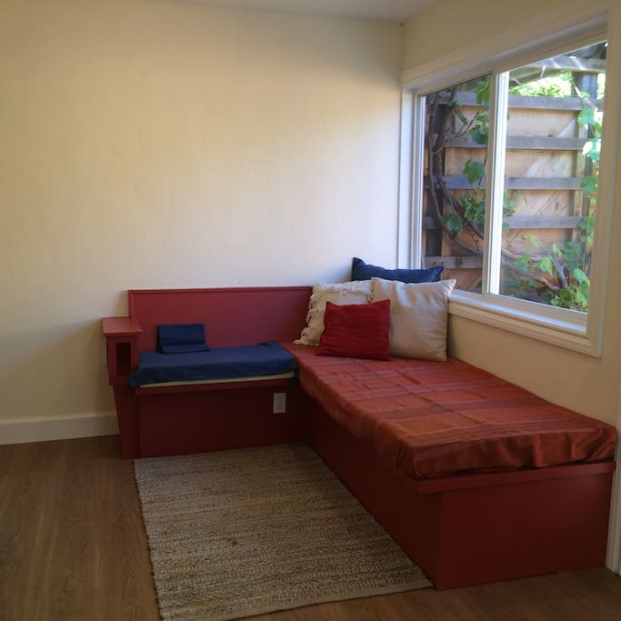 Window bench that also doubles as a second bed.