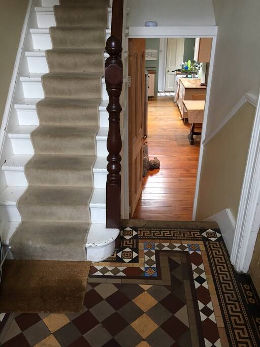 Entrance hall showing original Victorian Tiled floor and steps down to kitchen