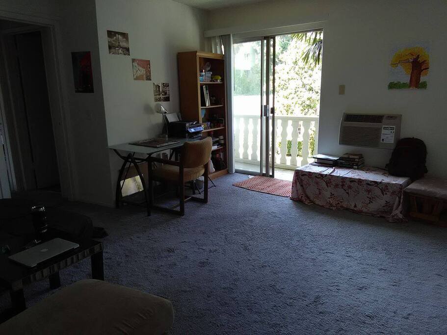 The living room, more desks, tables and couch