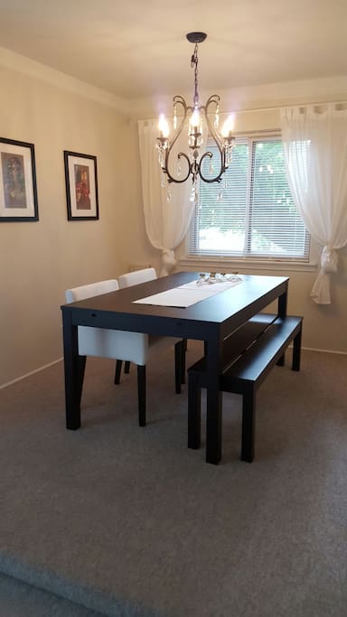 Attached to the main living room is the dinning room. Not only are the chairs comfy, the bench allows for extra room to set up a board game!