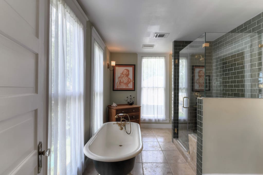 Full bathroom with stand up shower (and bench) and clawfoot tub. Sink is marble top.