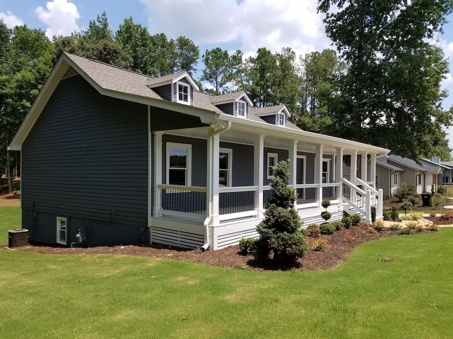 Charming Bungalow Next Door with inviting keeping porch for relaxation.