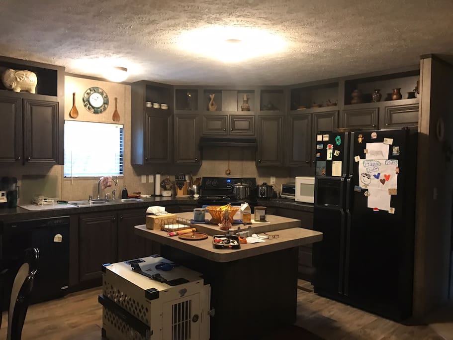 Kitchen with black appliances - fridge, microwave, stove, oven and dishwasher