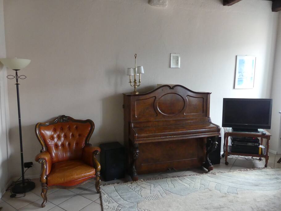 living room with TV and piano