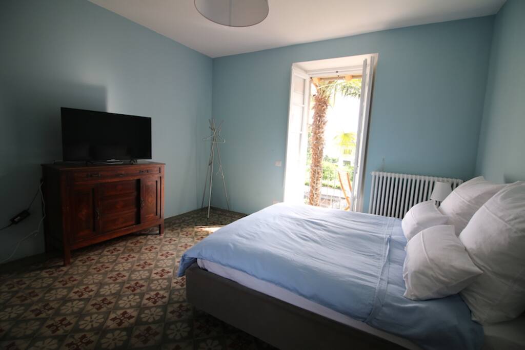 Schlafzimmer mit Balkon und Seeblick mit modernem Smart-TV