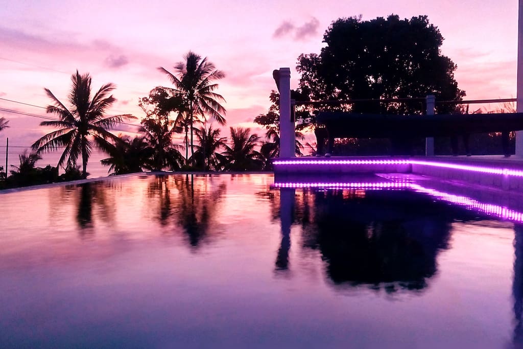 Sunset with the colour changeable LED lighting of the pool