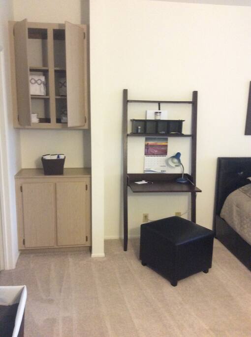This personal workstation has a desk lamp and office supplies for your convenience.
