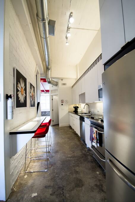 Kitchen with all the essentials with an eating counter.