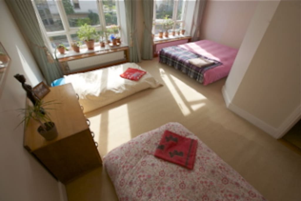 Main bedroom ready for three or four guests to cosy up ! Yes, breakfast is included but not in bed.