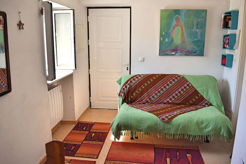 small living room in top entrance with sofa bed