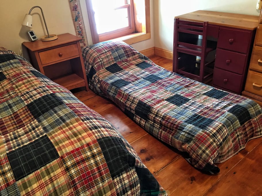 Bedroom#1- View of room with chair- floor bed opened up to accommodate a second guest.